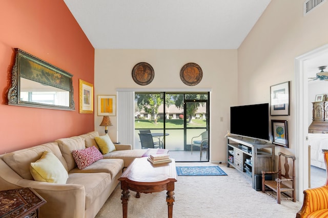 living area featuring carpet floors, visible vents, and a wealth of natural light