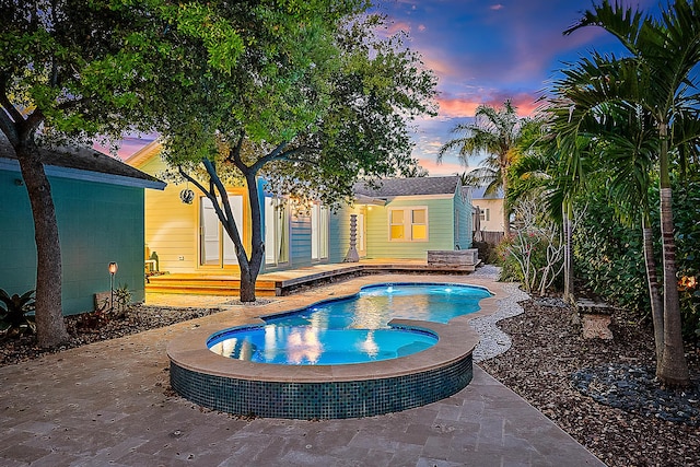 view of pool at dusk