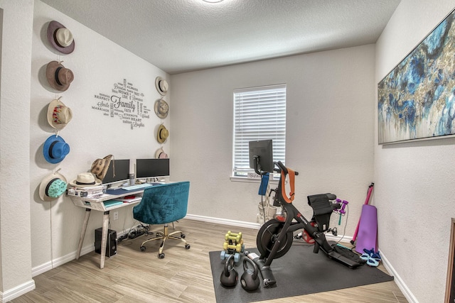 800 SE Villandry Way, Port Saint Lucie, FL 34984 - office area featuring wood finished floors, baseboards, a textured ceiling, and a textured wall