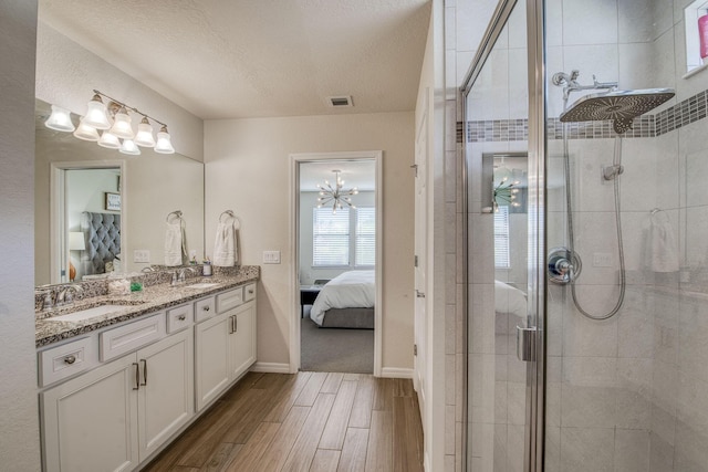 800 SE Villandry Way, Port Saint Lucie, FL 34984 - full bathroom featuring connected bathroom, wood finished floors, a shower stall, and a textured ceiling