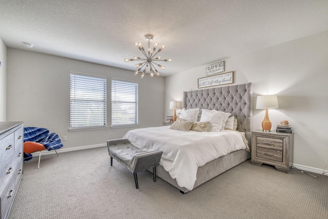 bedroom featuring light carpet, a notable chandelier, a textured ceiling, and baseboards