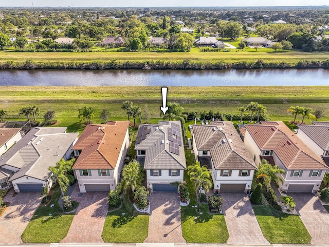 drone / aerial view featuring a residential view and a water view