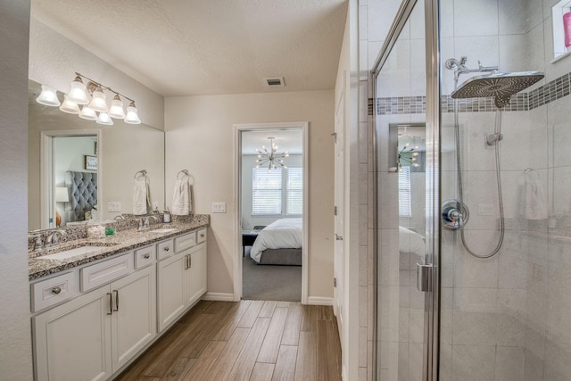 bathroom featuring ensuite bathroom, a sink, and a shower stall