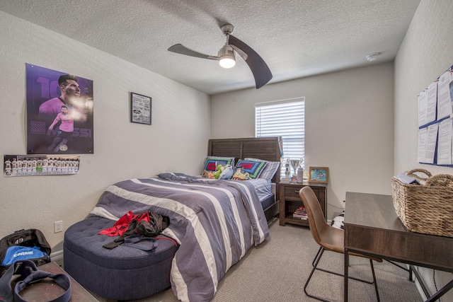 bedroom featuring light carpet, a textured ceiling, and a textured wall