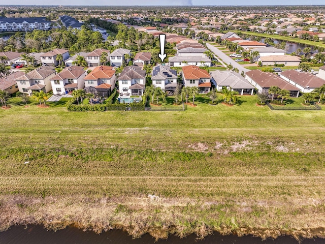 birds eye view of property with a water view and a residential view