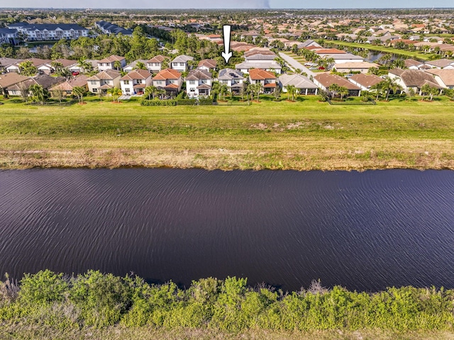 drone / aerial view with a water view and a residential view