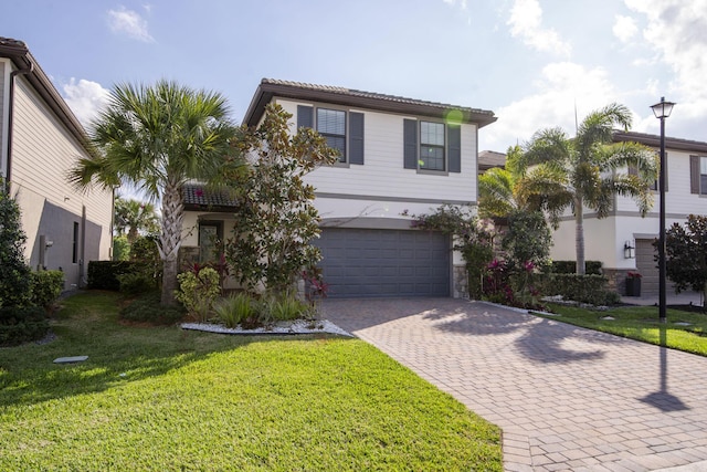 view of front facade featuring decorative driveway, stucco siding, a garage, stone siding, and a front lawn