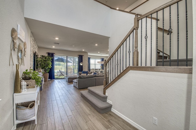 interior space featuring baseboards, wood finished floors, and recessed lighting