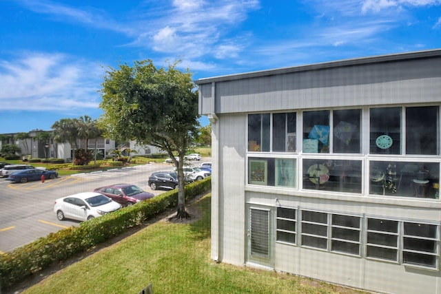 view of side of home with uncovered parking