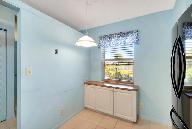 dining space with light tile patterned floors and baseboards