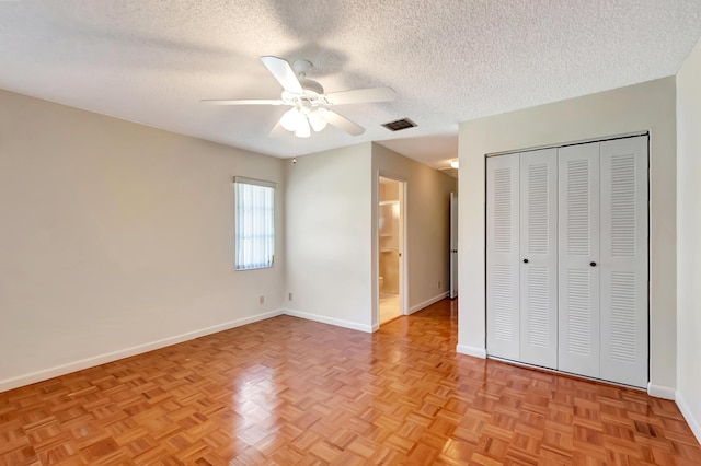 unfurnished bedroom with baseboards, visible vents, a ceiling fan, a textured ceiling, and a closet