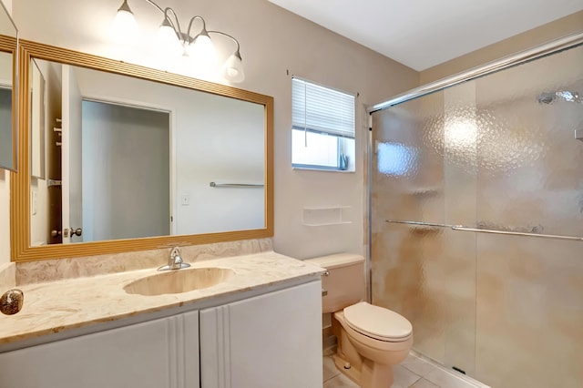 bathroom featuring tile patterned flooring, a shower stall, toilet, and vanity