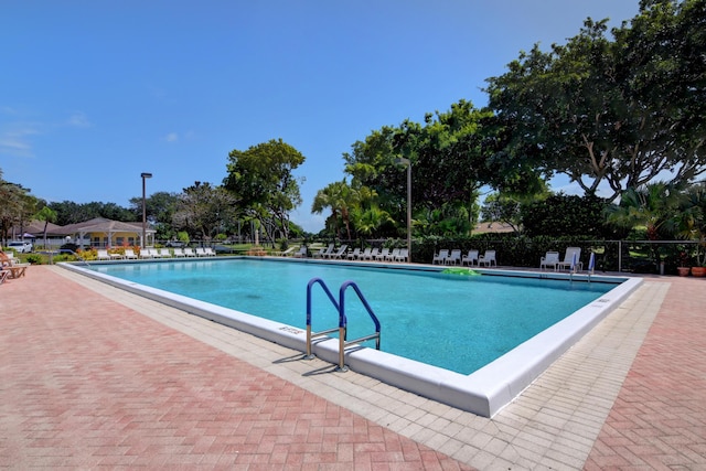 pool featuring fence and a patio