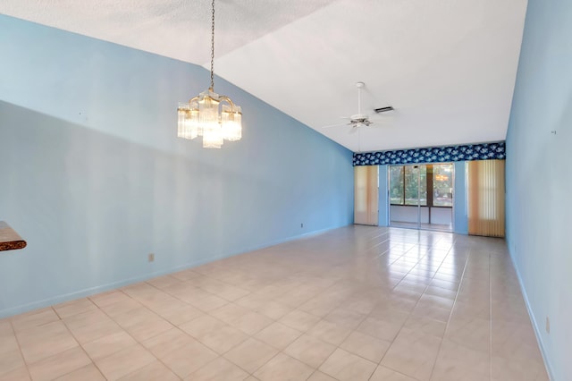 empty room featuring ceiling fan with notable chandelier, lofted ceiling, visible vents, and baseboards