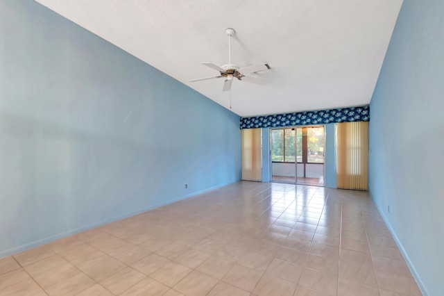 unfurnished room featuring lofted ceiling, light tile patterned floors, ceiling fan, and baseboards