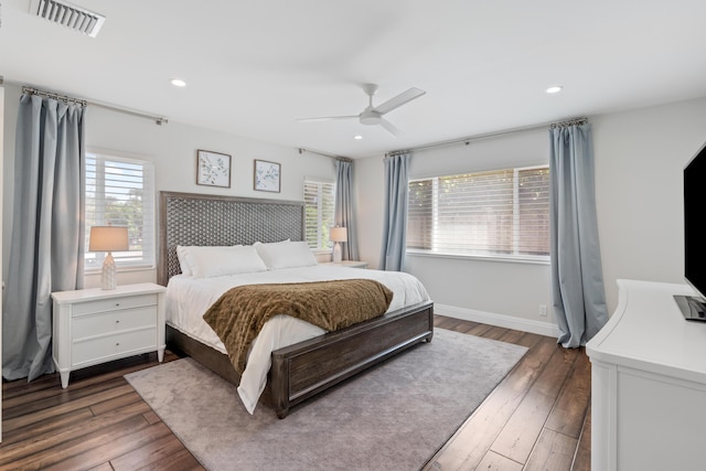 bedroom with recessed lighting, wood finished floors, a ceiling fan, baseboards, and visible vents