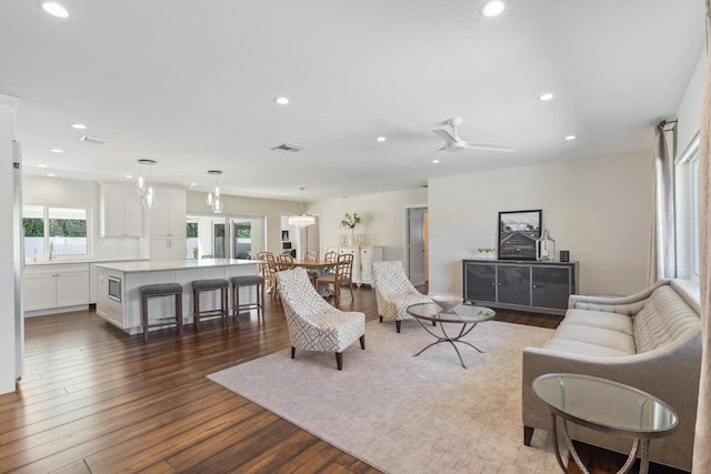 living room featuring ceiling fan, wood-type flooring, visible vents, and recessed lighting