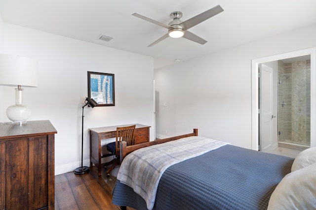 bedroom with baseboards, visible vents, hardwood / wood-style flooring, ensuite bath, and ceiling fan