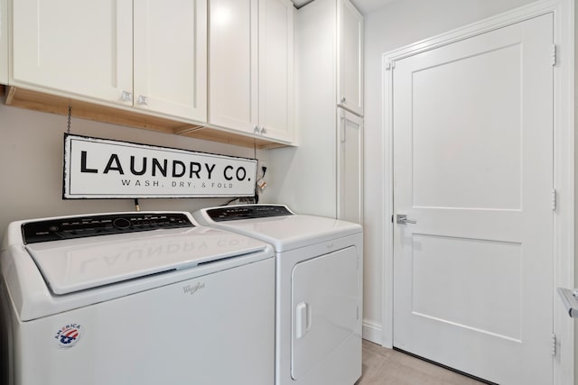 washroom with cabinet space and separate washer and dryer