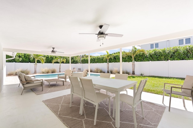 view of patio with a fenced in pool, outdoor dining space, a fenced backyard, and ceiling fan