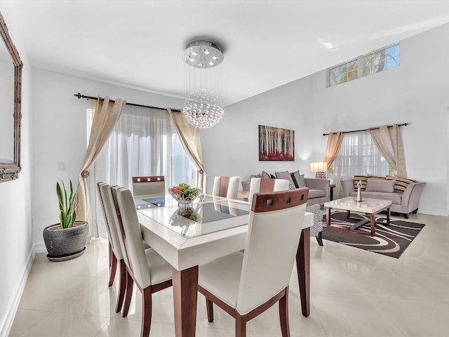 dining area with baseboards, plenty of natural light, light tile patterned flooring, and an inviting chandelier