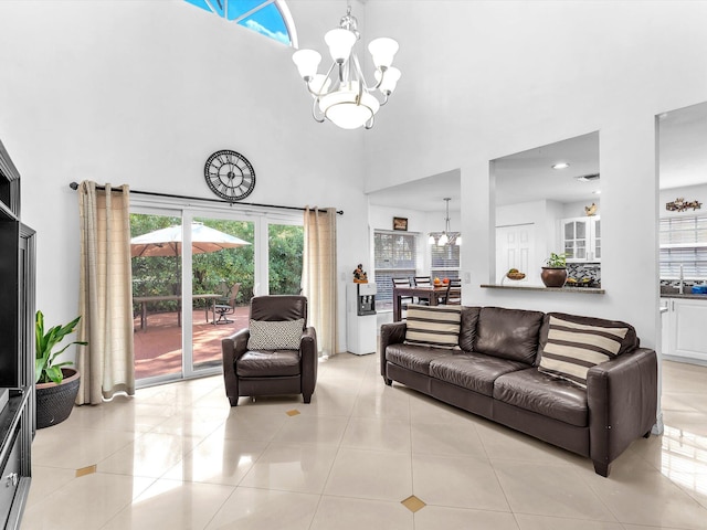 living room with light tile patterned floors, a towering ceiling, and an inviting chandelier