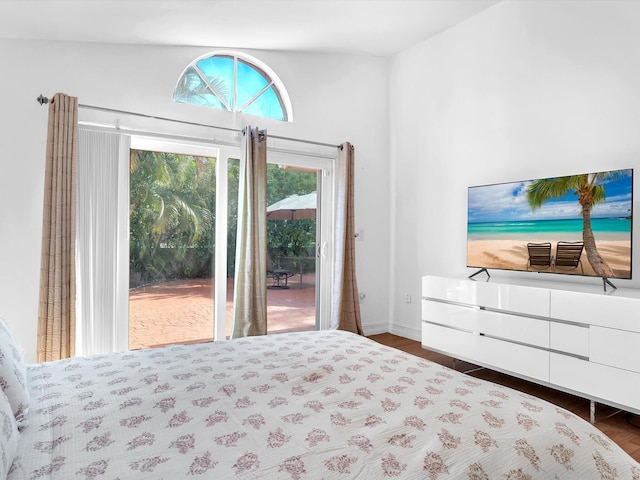 bedroom featuring wood finished floors and access to exterior