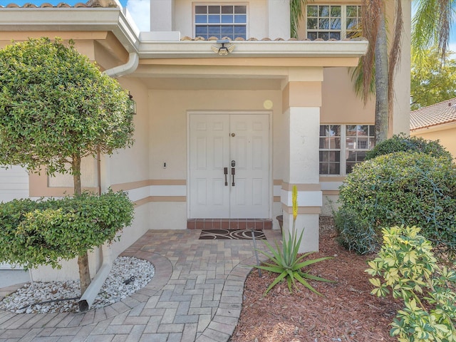 doorway to property with stucco siding