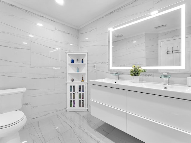 full bath featuring toilet, stone wall, visible vents, and a sink