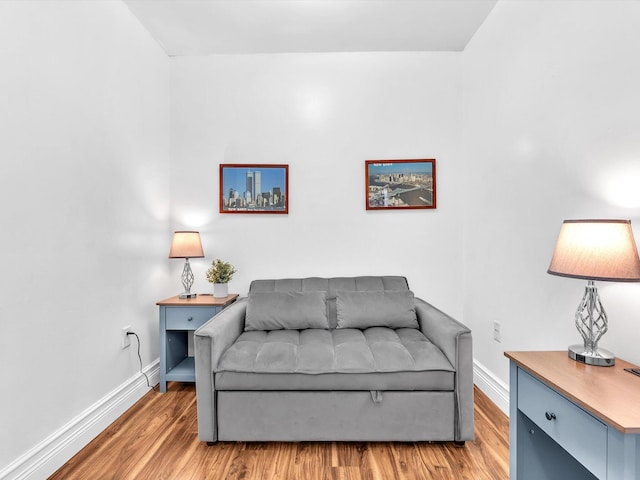sitting room featuring baseboards and wood finished floors