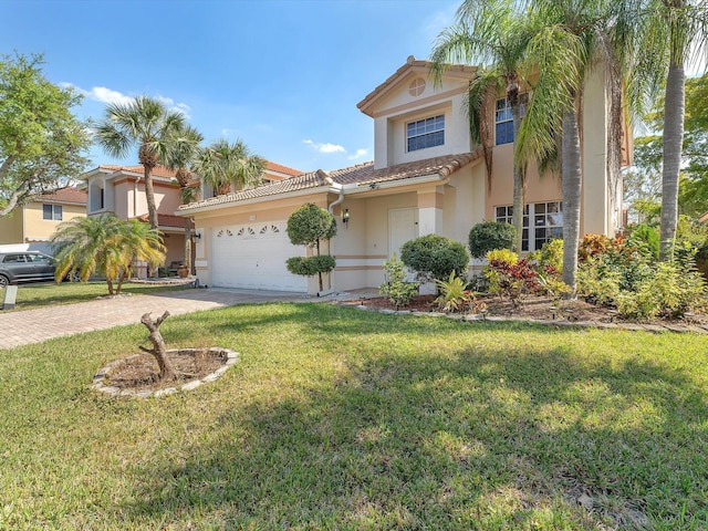 mediterranean / spanish home featuring decorative driveway, a tile roof, stucco siding, a garage, and a front lawn