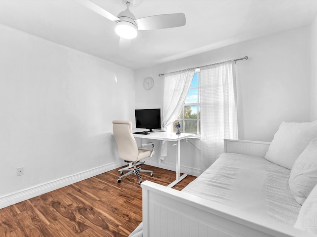 home office with wood finished floors, a ceiling fan, and baseboards