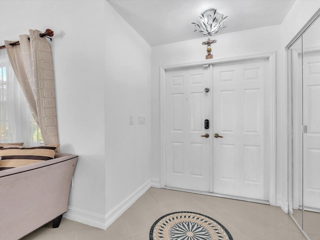 entrance foyer featuring light tile patterned floors and baseboards