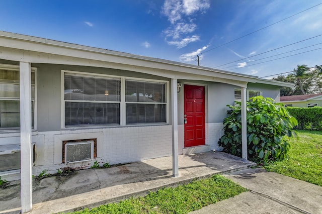 property entrance featuring brick siding