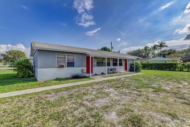 single story home with a front yard, cooling unit, and brick siding