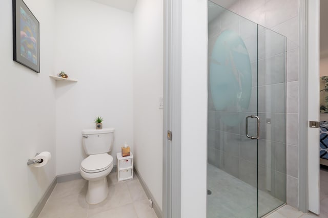 bathroom with toilet, a stall shower, tile patterned flooring, and baseboards