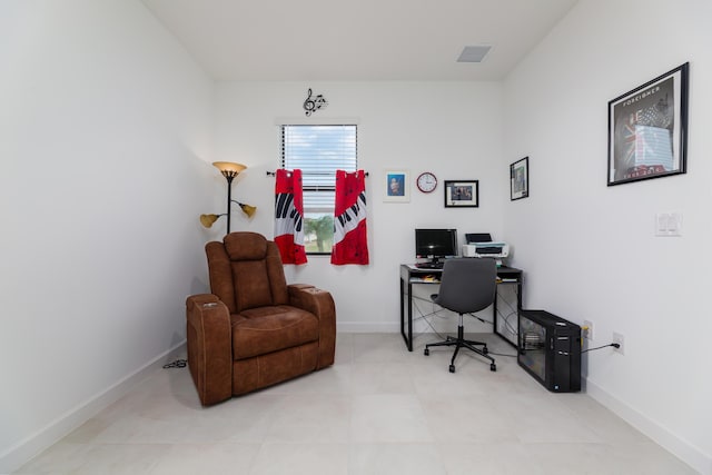 office area with tile patterned flooring, visible vents, and baseboards