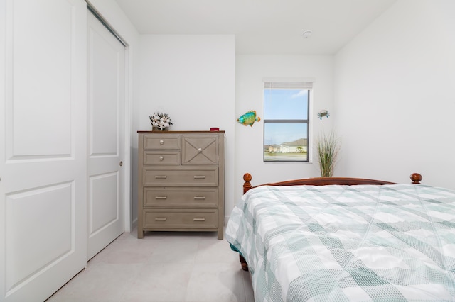 bedroom with light tile patterned floors and a closet