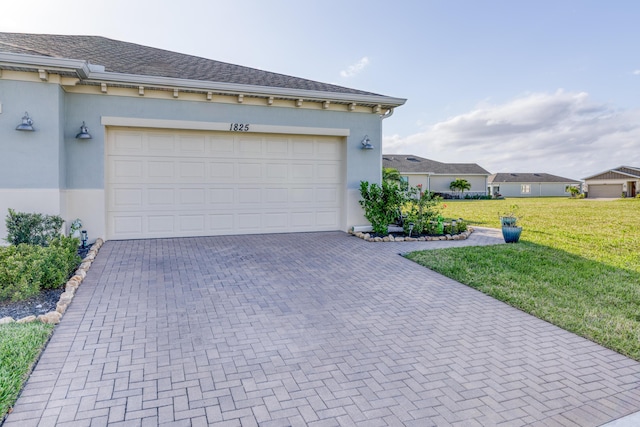 garage with decorative driveway