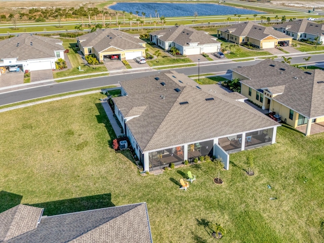 drone / aerial view with a water view and a residential view