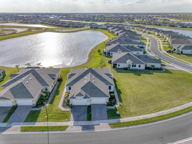 drone / aerial view with a residential view and a water view