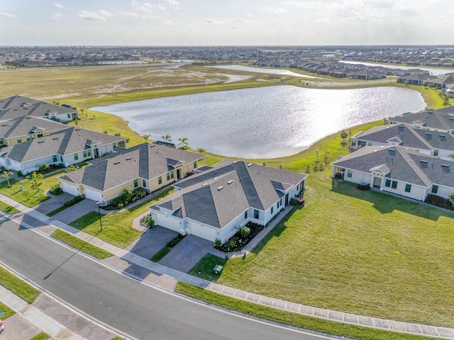 drone / aerial view featuring a water view and a residential view