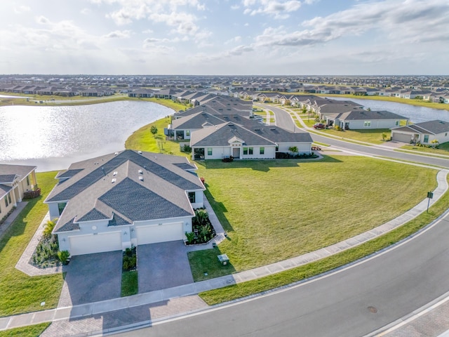 drone / aerial view with a residential view and a water view