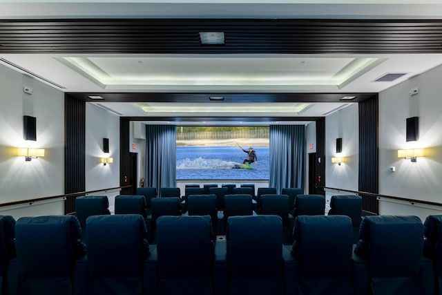 home theater featuring a raised ceiling and visible vents