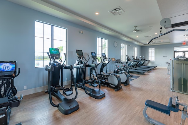 exercise room with recessed lighting, visible vents, baseboards, and wood finished floors