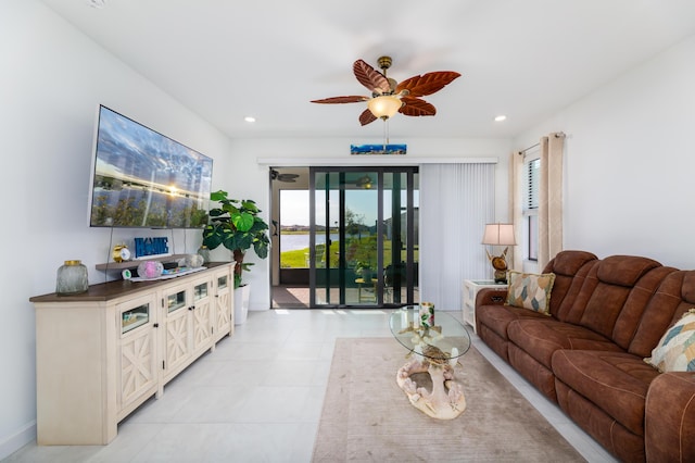 living room with a ceiling fan, recessed lighting, and light tile patterned floors