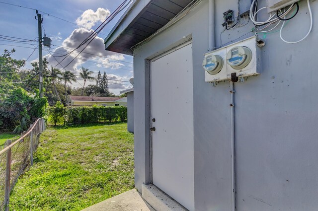 exterior details featuring fence, electric meter, and stucco siding