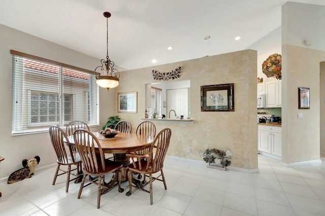 dining room featuring baseboards and recessed lighting