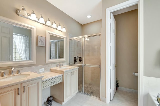 full bathroom featuring double vanity, a sink, and a shower stall