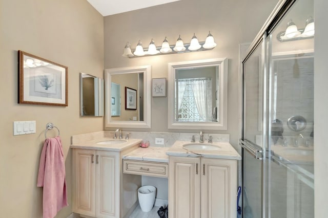 bathroom featuring a sink, a shower stall, and double vanity